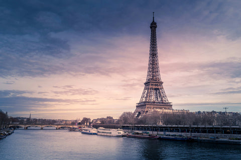 Best France eSIM plan for tourists — woman using smartphone while sightseeing in Paris.